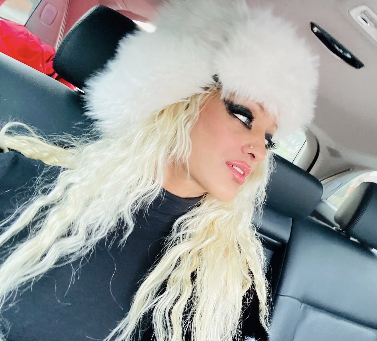 Angel Bottley wearing a white hat and black top