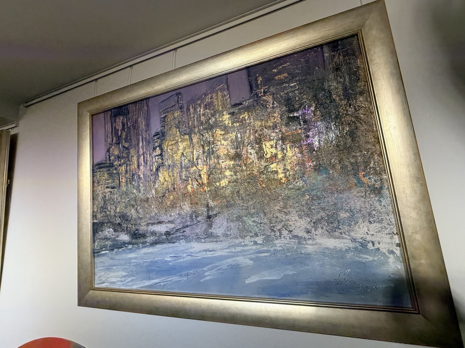 Framed winter cityscape showing snow-covered Central Park beneath a luminous New York skyline